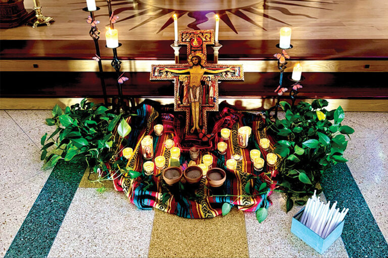 A shrine with lit candles in LMU Sacred Heart Chapel